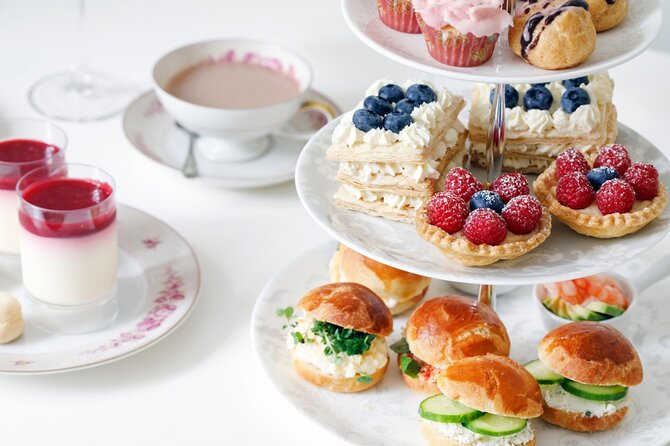 Afternoon High Tea in Burj Al Arab with Transfer - Sitting down for tea, pastries, and music