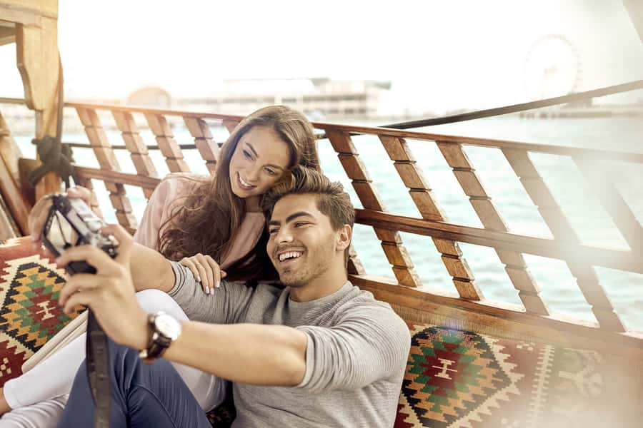 Dubai: Sunset Cruise on Traditional Boat & Emirati High Tea - Boarding a traditional Abra on the canal