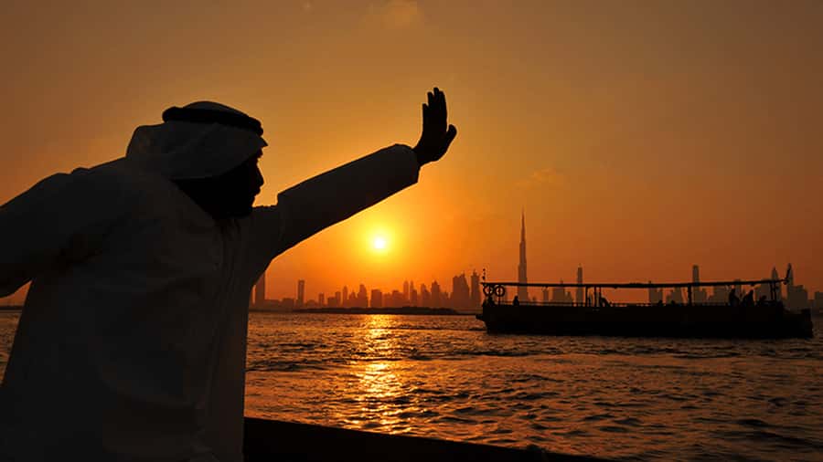 Dubai: Sunset Cruise on Traditional Boat & Emirati High Tea - Sunset behind the Burj Khalifa